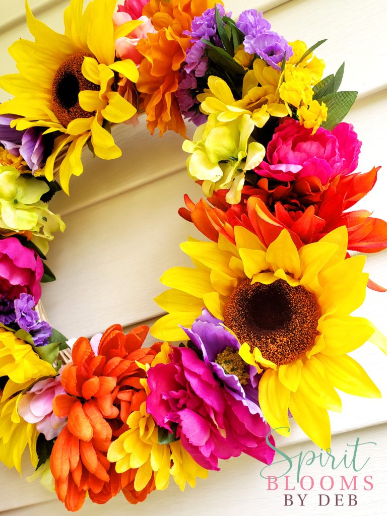 Close-up of sunflower and colorful flowers on handmade wreath by Spirit Blooms by Deb.