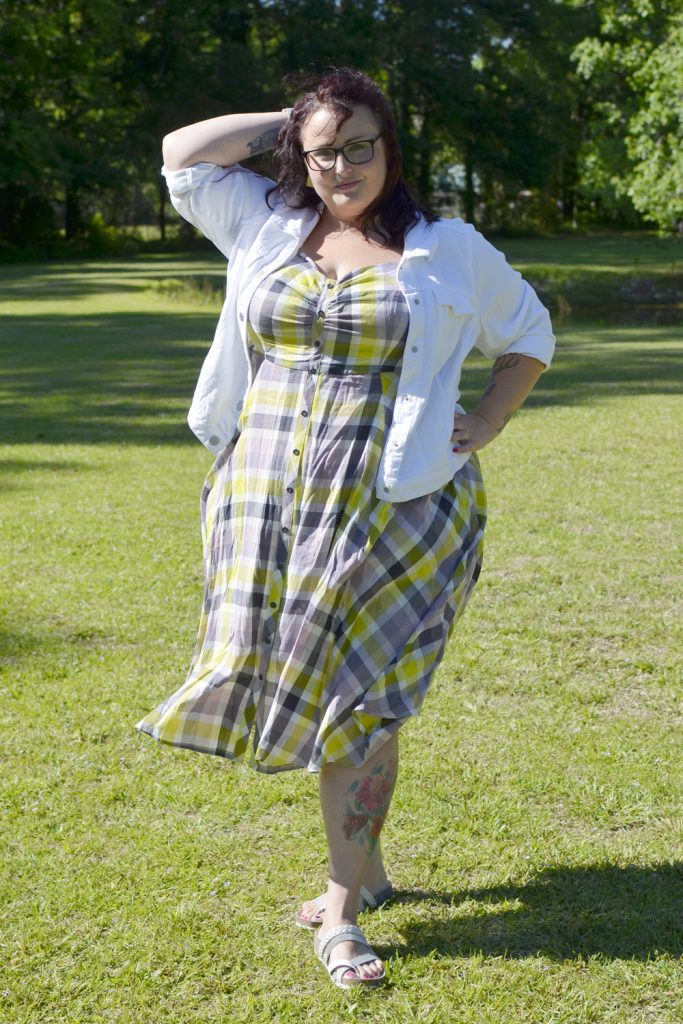 Maranda, a plus size woman, models Outfit of the Day wearing a plaid Torrid dress with white denim jacket.