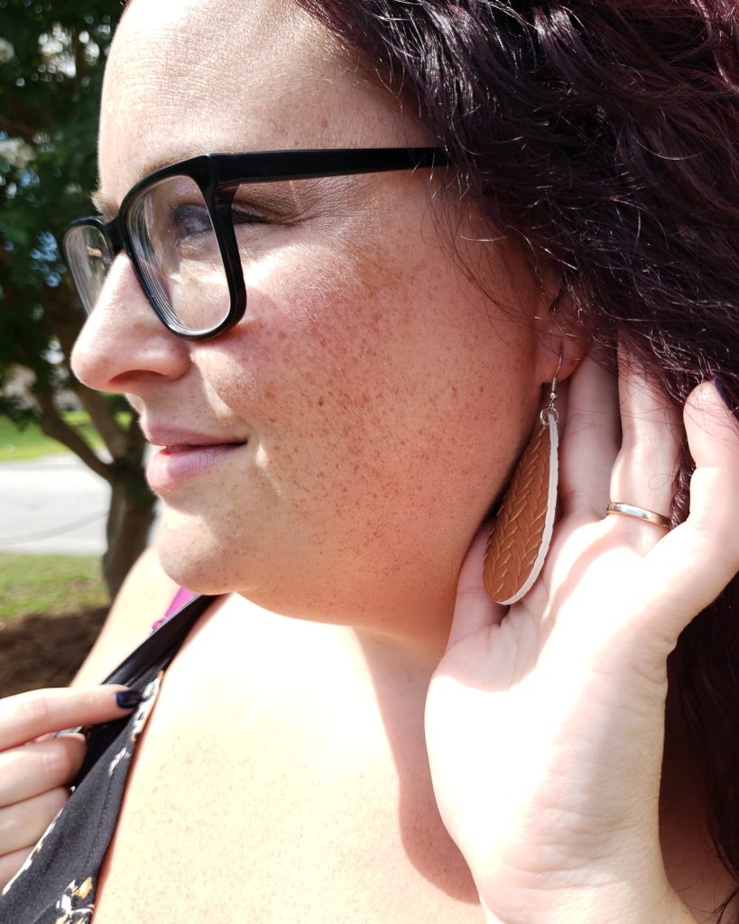 Close-up of Maranda modeling shiny metallic gold water drop earrings from Shein.