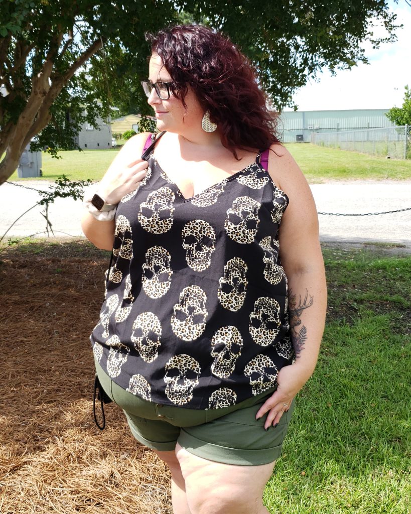 Maranda, a plus size woman, wearing a Shein cami top with leopard print skulls over olive green utility shorts by Terra & Sky.