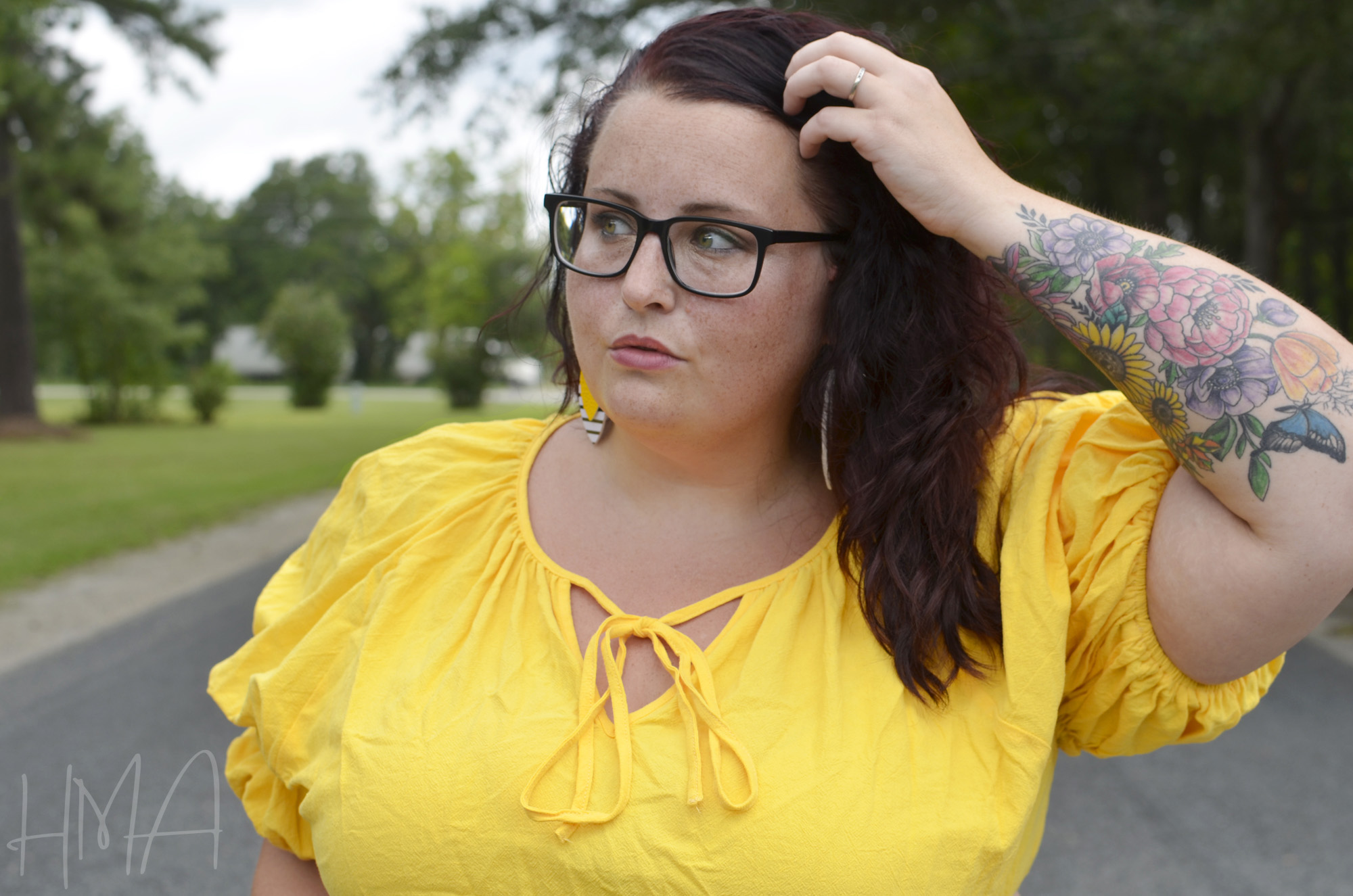 Close-up of Maranda, a plus size woman, wearing a yellow top from Shein with ties on the neckline.