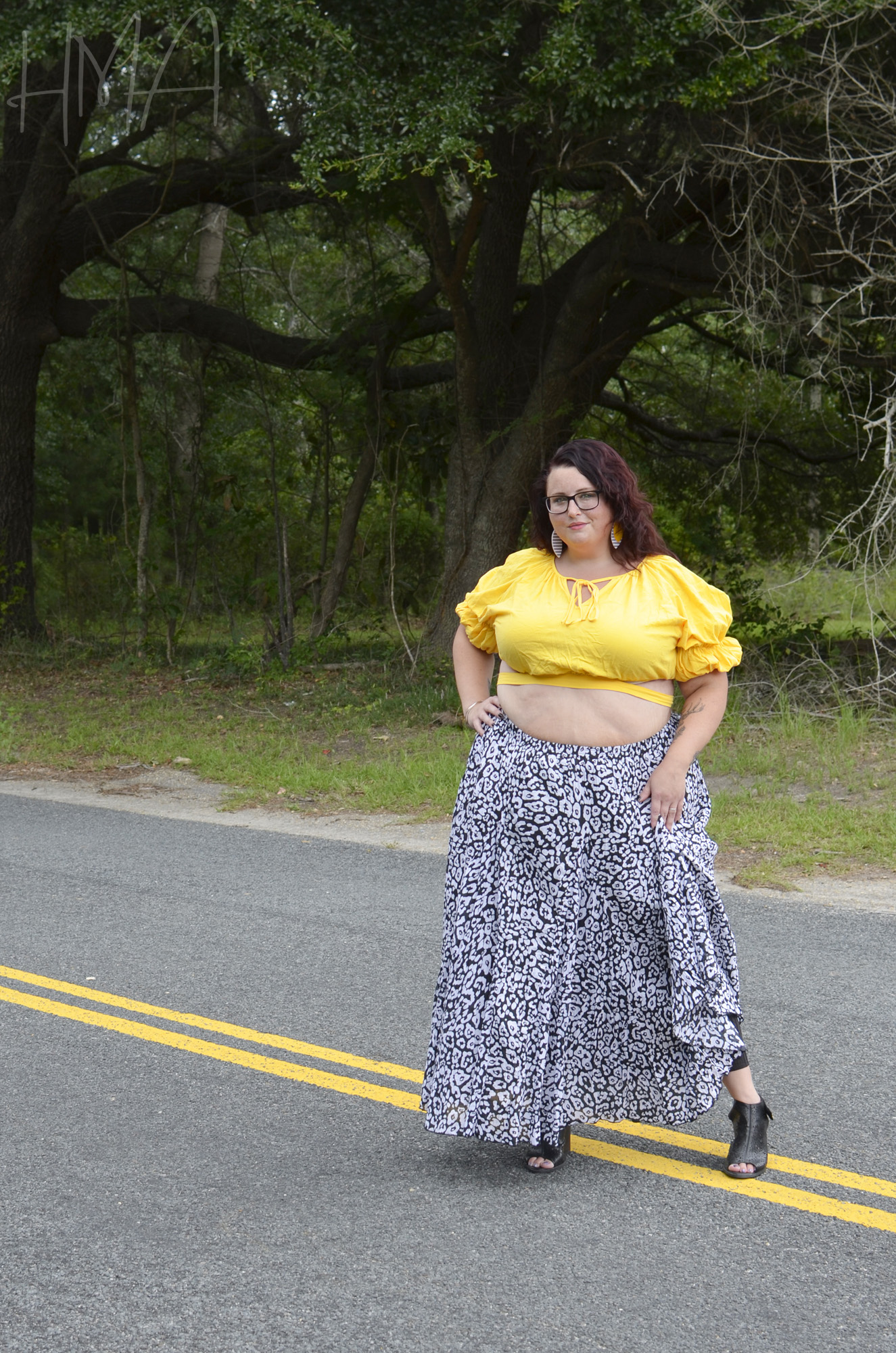 Maranda, a plus size woman, models a Jessica London flowing crinkle maxi skirt and yellow Shein crop top.