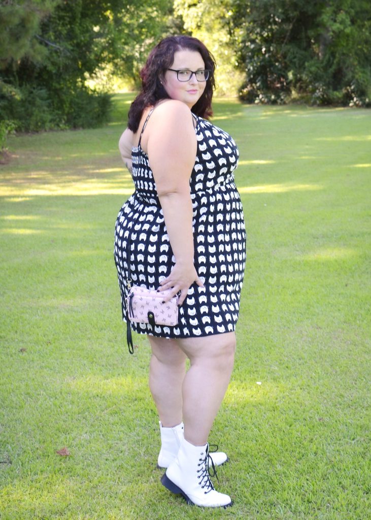Maranda, a plus size woman, models a black and white cat face dress from As U Wish brand outdoors.