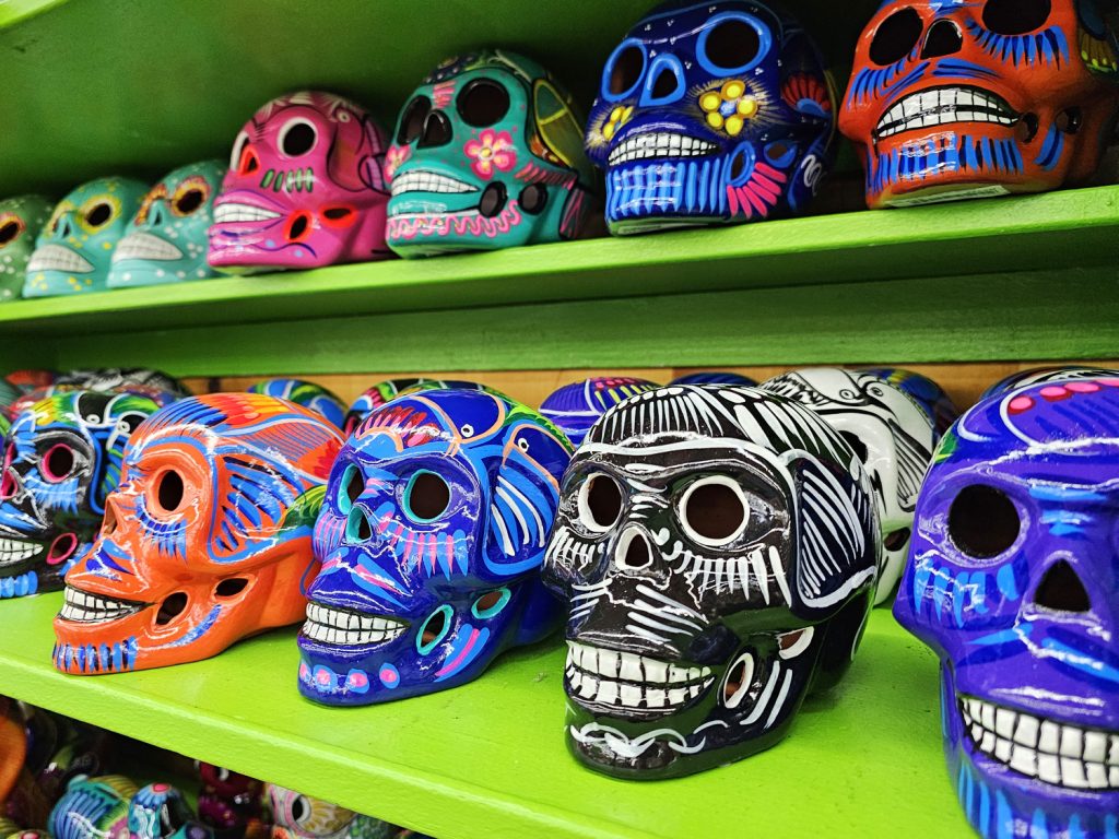 Colorfully hand-painted ceramic Mexican calavera skulls on sale display at South of the Border's Mexico Shop East.