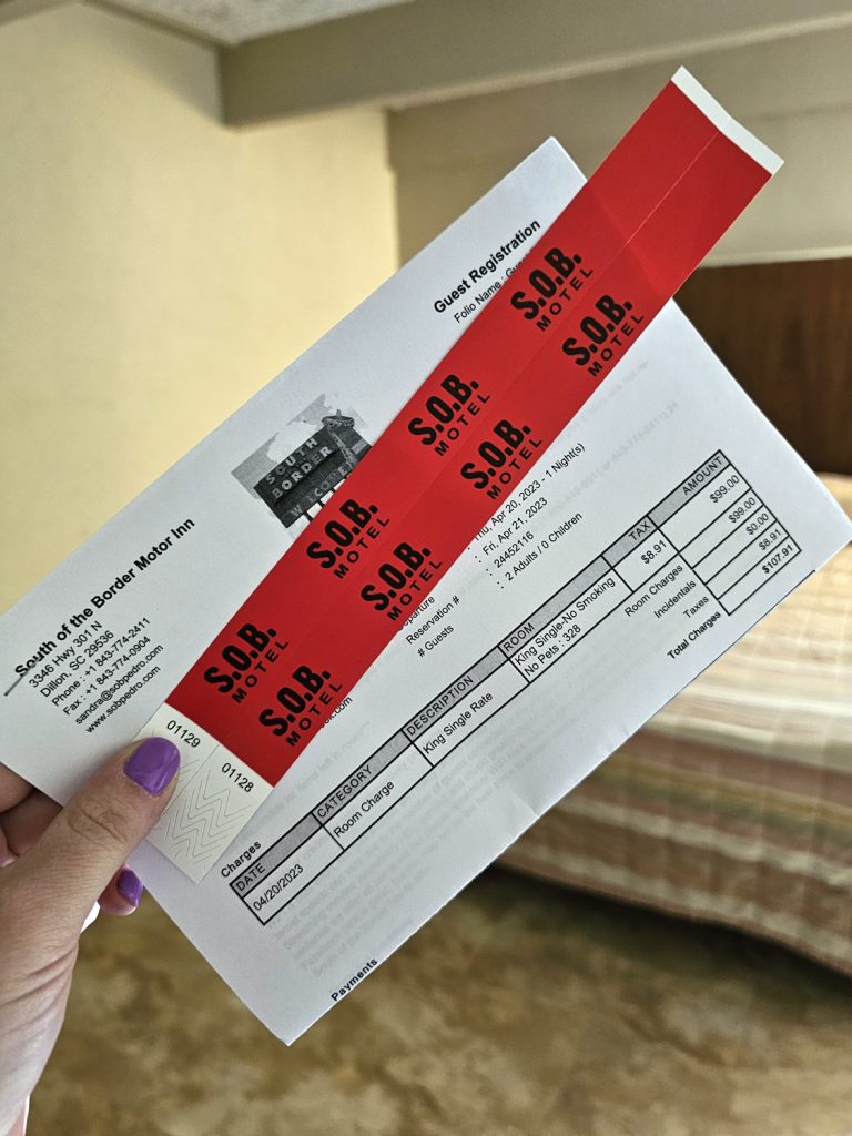 South of the Border pool wristbands and printed guest registration sheet showing total cost for one night's stay at a little over $100.